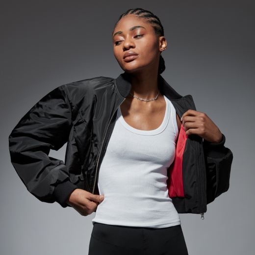 Model wears NAOMI In Fashion cropped bomber jacket by BOSS - open, showing a flash of red interior and puff sleeve